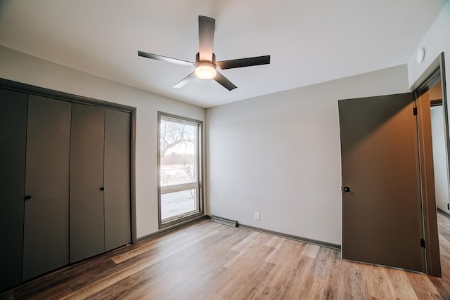 unfurnished bedroom featuring ceiling fan, a closet, and light hardwood / wood-style floors