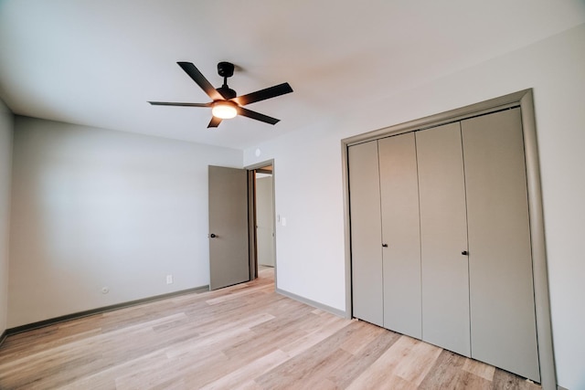 unfurnished bedroom with ceiling fan, a closet, and light hardwood / wood-style flooring