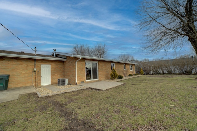 back of house featuring a patio area, central AC unit, and a lawn