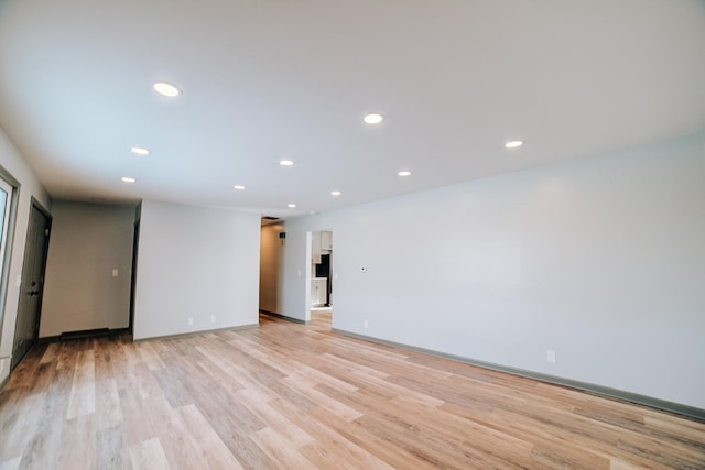 spare room with light hardwood / wood-style floors