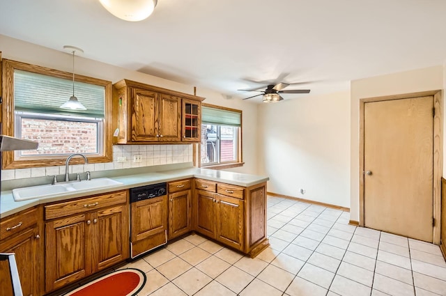 kitchen with decorative light fixtures, sink, backsplash, kitchen peninsula, and paneled dishwasher