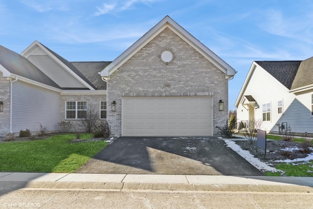 view of front of house with a front yard and a garage