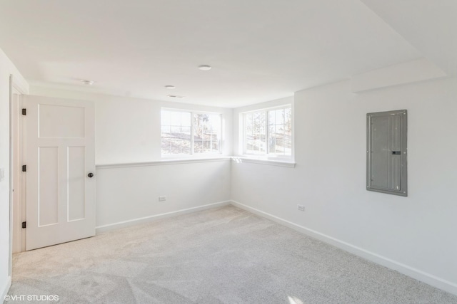 empty room featuring light colored carpet and electric panel