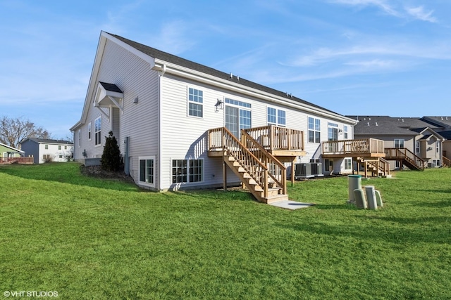 rear view of house featuring central AC unit, a lawn, and a wooden deck