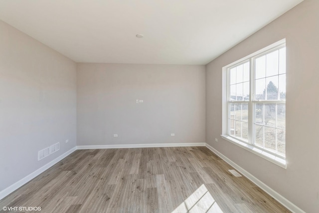 spare room with light hardwood / wood-style flooring