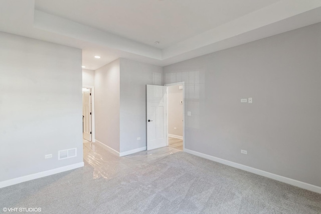 spare room featuring a raised ceiling