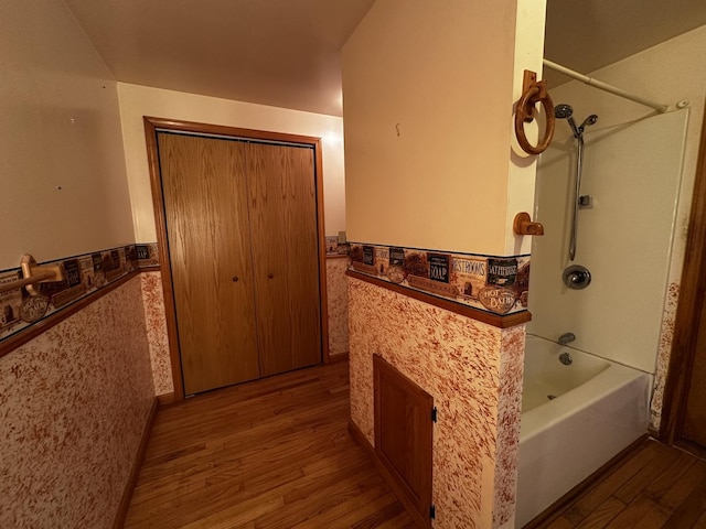 bathroom with shower / bath combination and wood-type flooring
