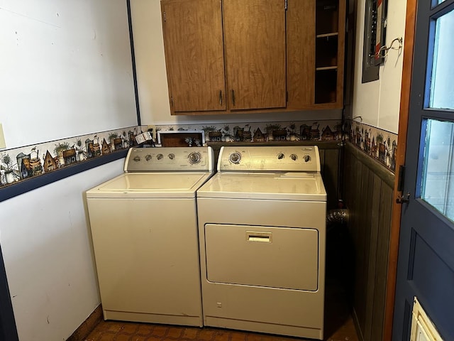 clothes washing area with independent washer and dryer and cabinets