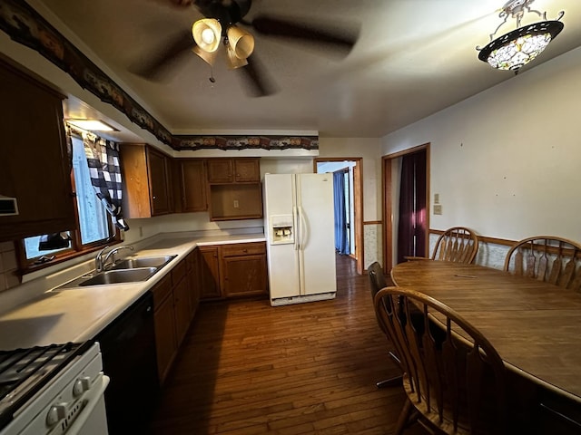 kitchen with dishwasher, white refrigerator with ice dispenser, ceiling fan, sink, and dark hardwood / wood-style flooring