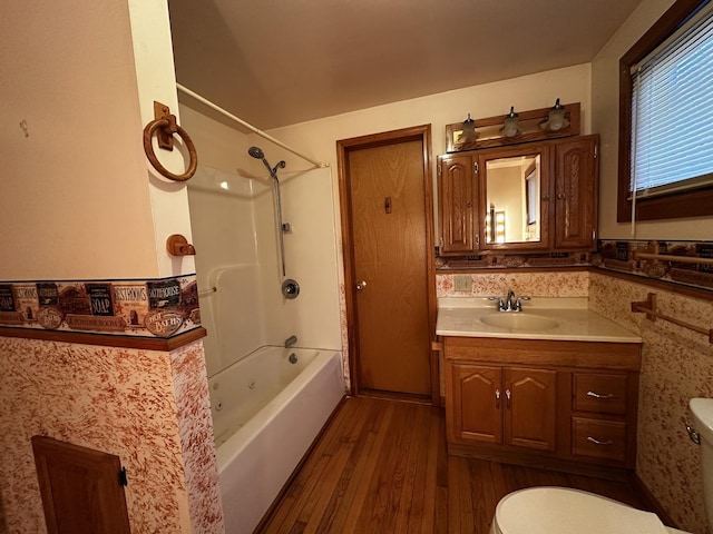 full bathroom featuring wood-type flooring, toilet, shower / washtub combination, and vanity