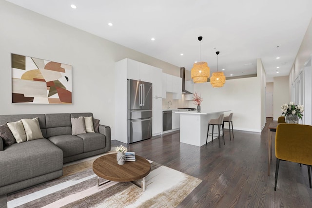 living room featuring dark wood-type flooring and sink