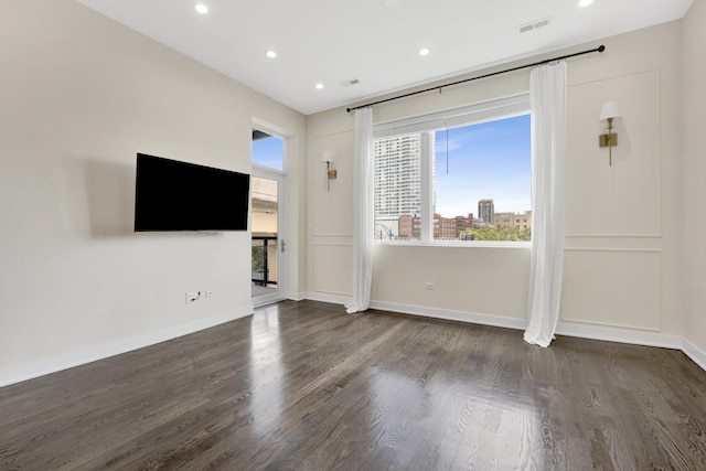 unfurnished living room with dark wood-type flooring