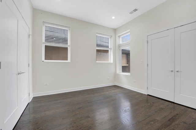 unfurnished bedroom featuring dark hardwood / wood-style flooring