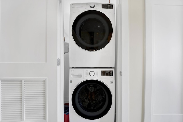 laundry room with stacked washing maching and dryer