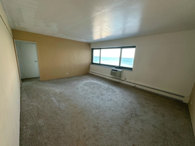 7337 S S Shore Dr Unit 503, Chicago, IL 60649 - unfurnished room featuring carpet flooring, an AC wall unit, and a baseboard heating unit