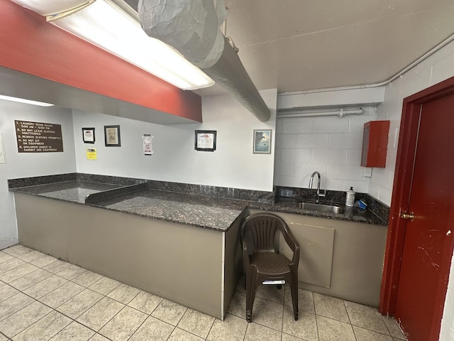 7337 S S Shore Dr Unit 503, Chicago, IL 60649 - kitchen featuring a sink, light tile patterned flooring, and dark stone countertops
