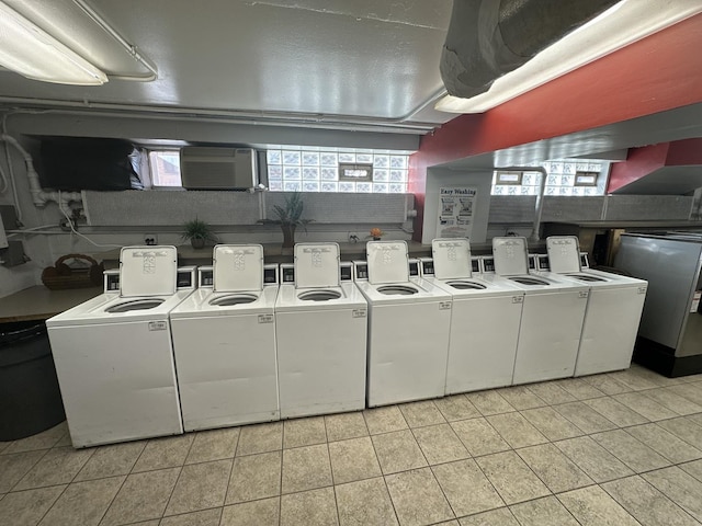 7337 S S Shore Dr Unit 503, Chicago, IL 60649 - community laundry room with a wall unit AC, light tile patterned flooring, and independent washer and dryer