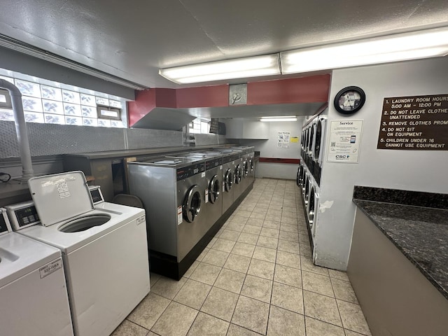7337 S S Shore Dr Unit 503, Chicago, IL 60649 - common laundry area featuring light tile patterned floors, a textured ceiling, stacked washer and dryer, and washing machine and clothes dryer