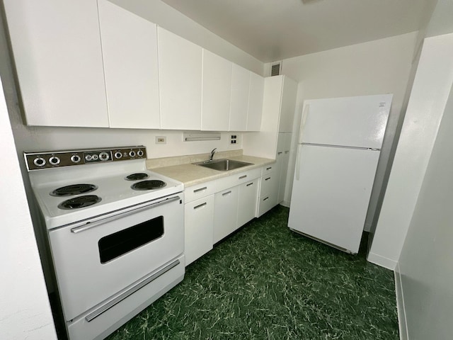 7337 S S Shore Dr Unit 503, Chicago, IL 60649 - kitchen featuring a sink, white cabinetry, white appliances, dark floors, and light countertops