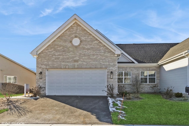 view of front facade with a garage and a front lawn