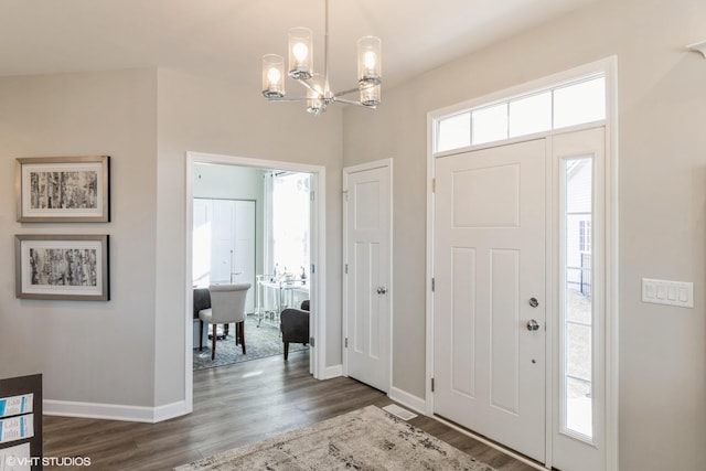 foyer featuring a chandelier, dark hardwood / wood-style floors, and plenty of natural light