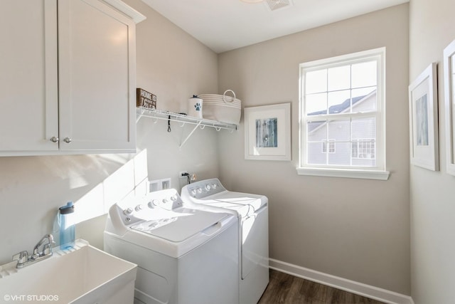 laundry room featuring cabinets, sink, dark hardwood / wood-style floors, and washer and dryer