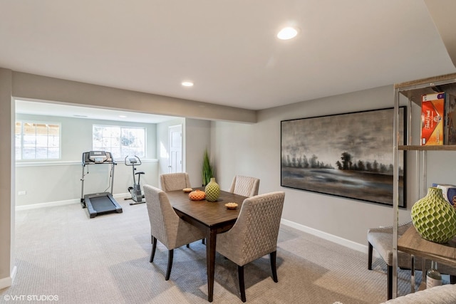 dining area featuring light carpet