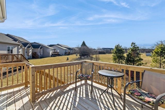 wooden deck with a lawn