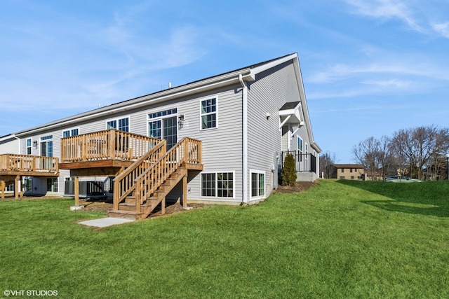 rear view of property featuring a wooden deck and a yard