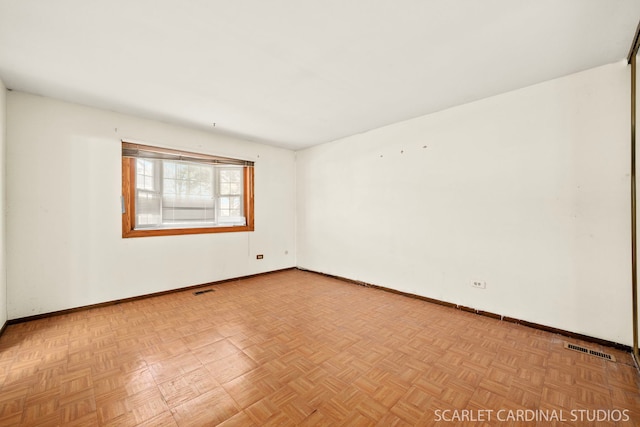 unfurnished room with light parquet flooring