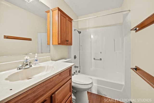 full bathroom featuring vanity, hardwood / wood-style flooring, shower / tub combination, and toilet