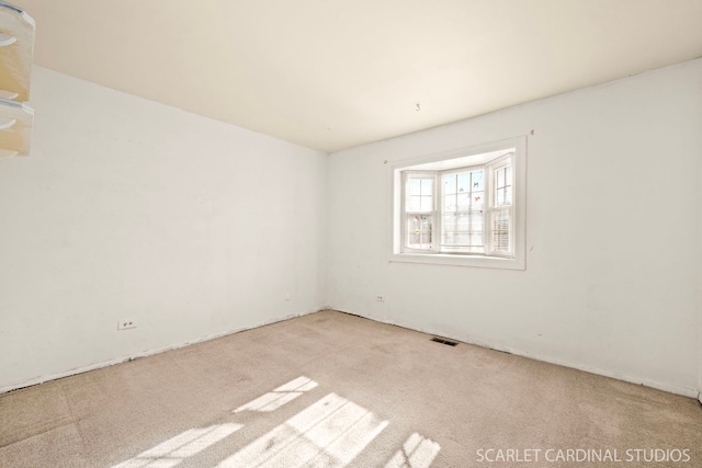 empty room with light colored carpet