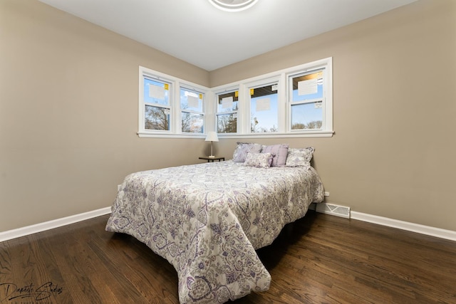 bedroom featuring dark hardwood / wood-style flooring