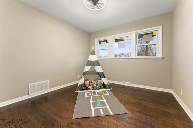 game room with dark wood-type flooring