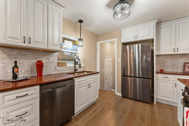 kitchen featuring sink, white cabinetry, and stainless steel appliances