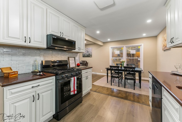 kitchen featuring dishwasher, white cabinetry, light hardwood / wood-style floors, backsplash, and stainless steel gas range oven