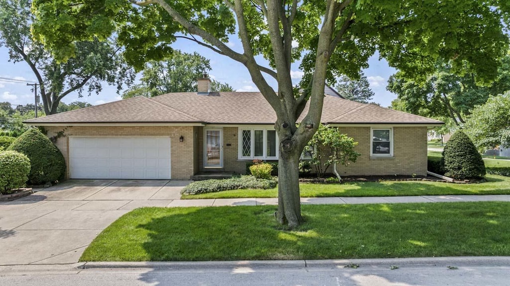 ranch-style home featuring a garage and a front yard