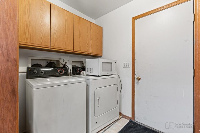 laundry area featuring cabinets and separate washer and dryer