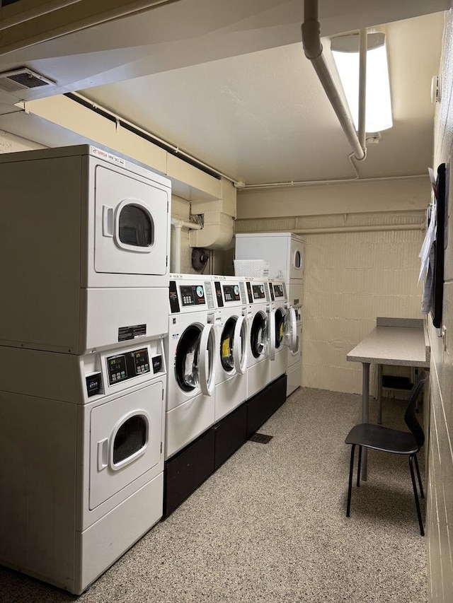 clothes washing area with independent washer and dryer and stacked washer and dryer