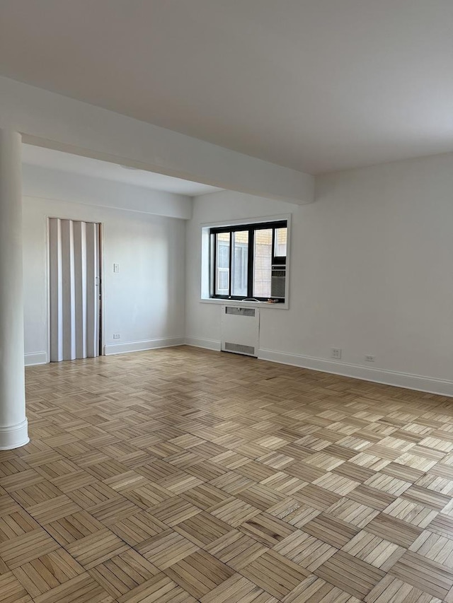 empty room with radiator and light parquet flooring