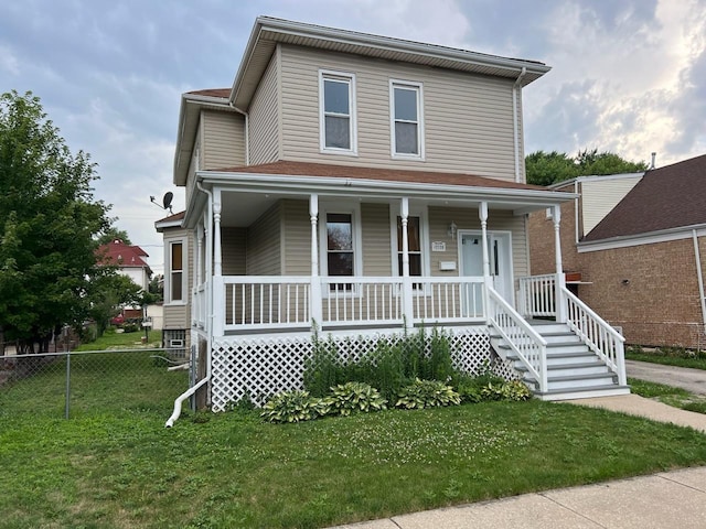 view of front facade with a front yard and a porch