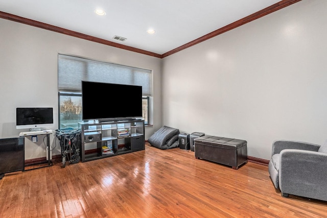 living room with crown molding and hardwood / wood-style floors