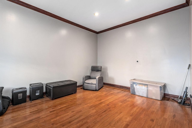 misc room with wood-type flooring and ornamental molding