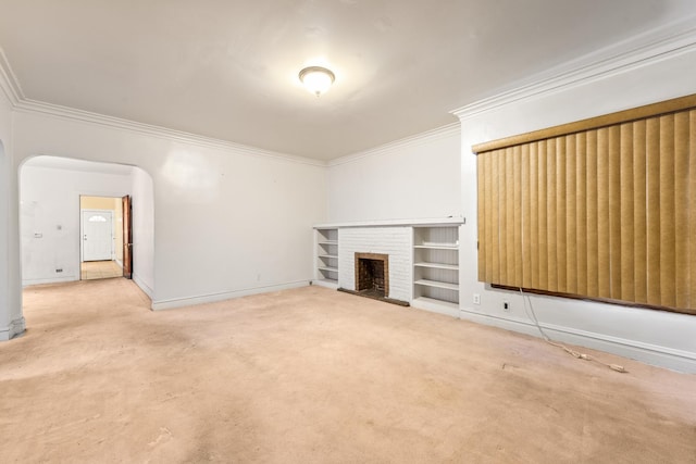 unfurnished living room with crown molding, carpet flooring, and a brick fireplace