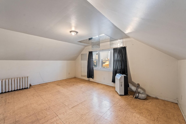 bonus room featuring radiator heating unit and vaulted ceiling