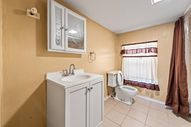 bathroom featuring vanity, tile patterned floors, and toilet