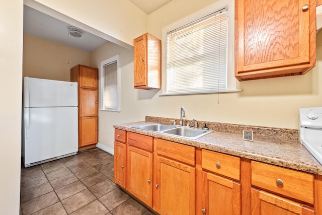 kitchen with white fridge, sink, and range