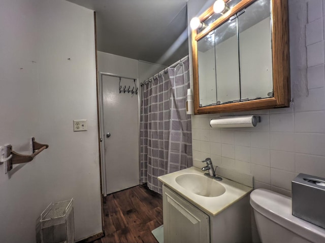 bathroom featuring vanity, tasteful backsplash, tile walls, toilet, and hardwood / wood-style flooring