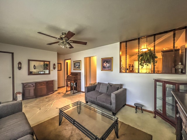 carpeted living room with ceiling fan