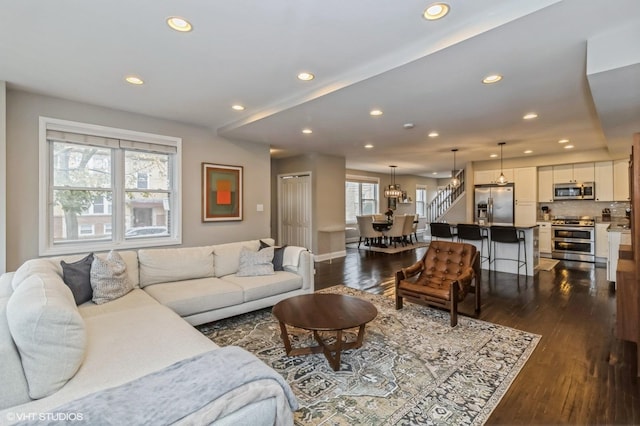 living room featuring dark hardwood / wood-style floors and plenty of natural light